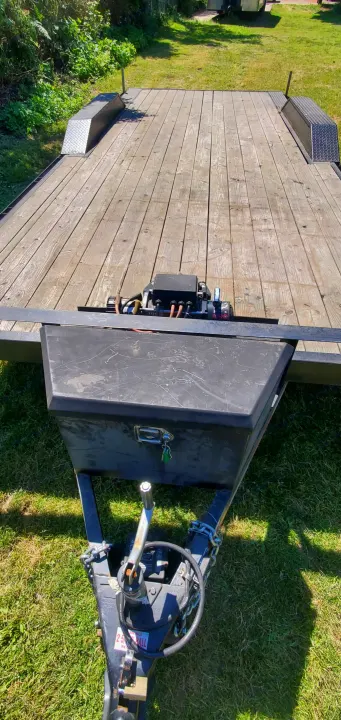 This utility trailer, ideal for RV rental needs, features a front winch, toolbox, and sturdy wooden deck for versatile hauling.. Eagle flatbed 2019