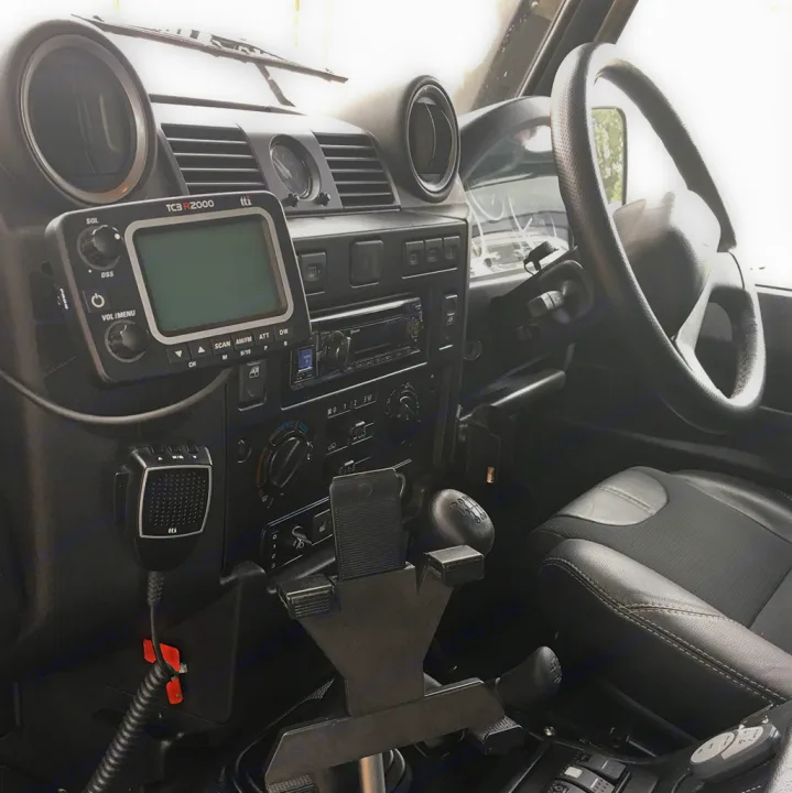 Land Rover Defender dashboard, equipped for adventure. Features CB radio, tablet mount, & steering wheel—ideal for your RV rental.. Land Rover Defender 110 XS Utility + 2 Roof Tents 2013