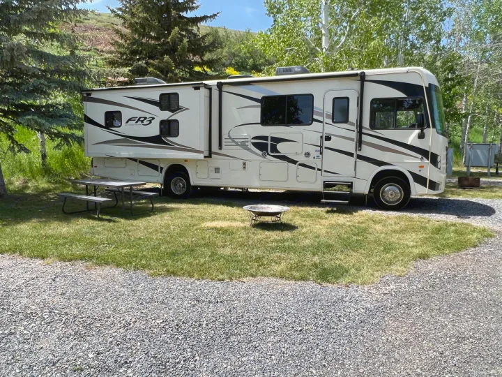 FR3 RV rental parked at a sunny campsite with picnic table and fire pit.. Other Other 2018
