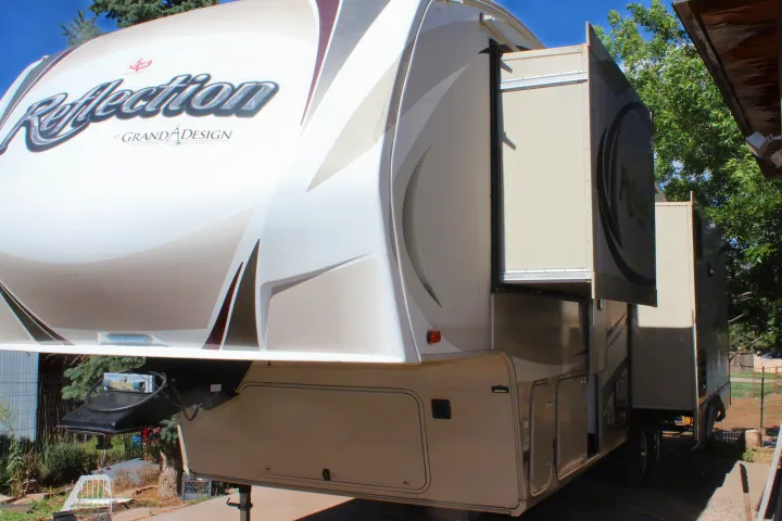 Reflection fifth-wheel RV rental with slide-outs extended, parked outdoors, ready for your next adventure.. Grand Design Reflection 2015