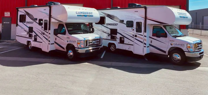 Two Graner RV rental motorhomes, Conquest models, parked at their facility, ready for rental adventures.. Gulf Stream Conquest 2022