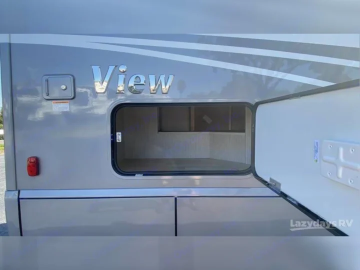 Spacious exterior storage of a 'View' RV shown open, ready for gear on your next rv rental adventure.. Winnebago View 2023