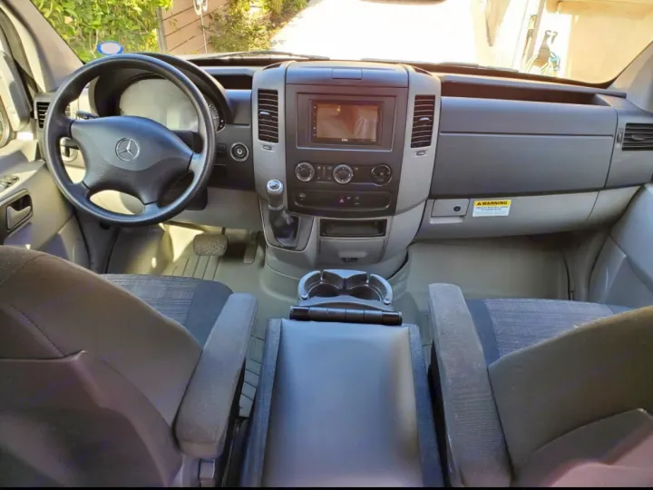 RV rental: Driver's perspective of a Mercedes-Benz Sprinter van interior, showing dashboard, wheel, and seats.. Mercedes-Benz Sprinter RV Motorhome Campervan 2016