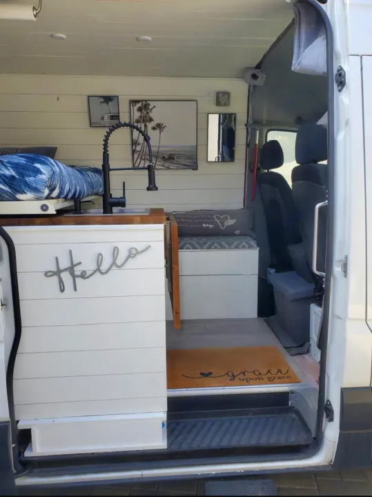 Step into this bright RV rental camper van, featuring a modern kitchen sink, comfy bed, and cozy seating area.. Mercedes-Benz Sprinter RV Motorhome Campervan 2016