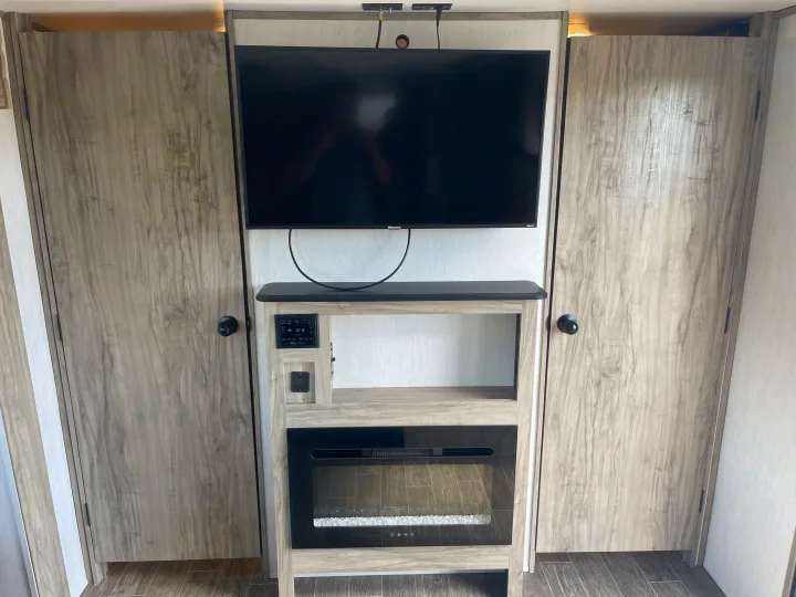 RV rental: Modern interior featuring a TV, entertainment center with fireplace, and spacious storage closets.. Forest River Cherokee Alpha Wolf 2021