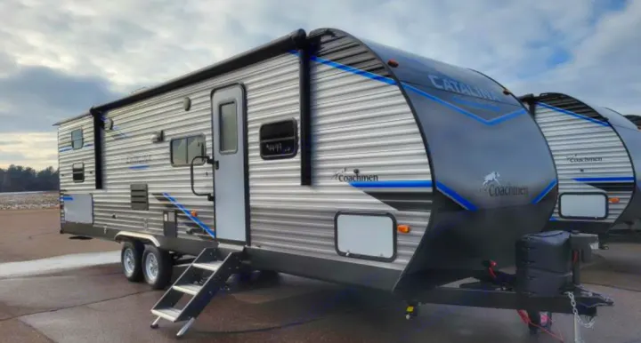 Outdoor kitchen includes small fridge, sink and propane double burner stove top . Coachmen Other 2019