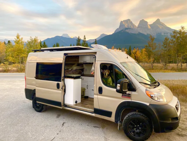 Explore scenic routes in an RV rental! This camper van with a dog inside offers mountain views and autumn colors.. Dodge Ram 1500 2020
