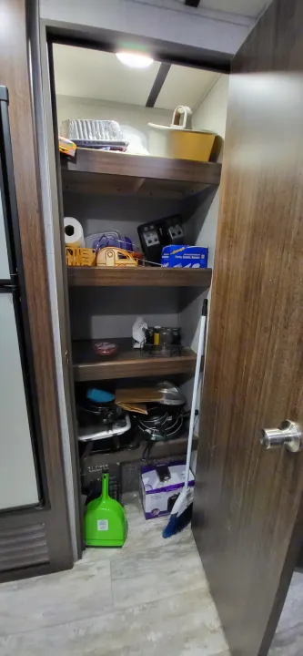 RV rental: Under-cabinet storage neatly organizing kitchen essentials like cookware, flatware, toaster, and cleaning supplies.. Crossroads RV Zinger Lite 2020