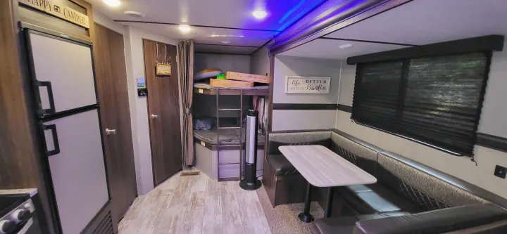 Cozy RV rental interior with bunk beds, dinette, and kitchen area. Perfect for a family getaway.. Crossroads RV Zinger Lite 2020