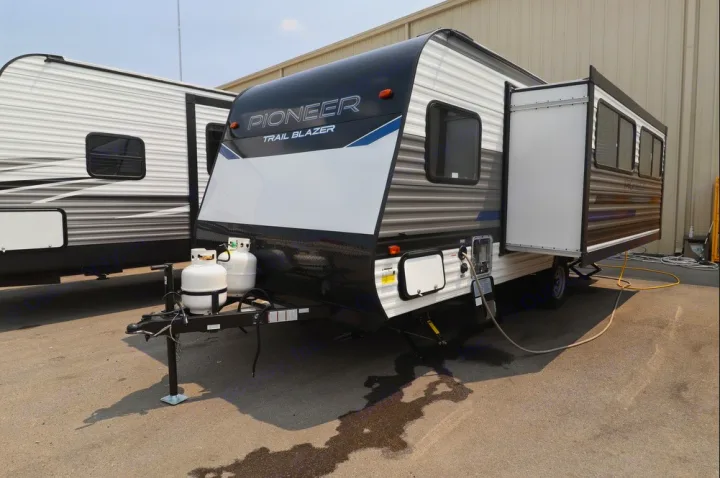 A modern Pioneer Trail Blazer RV, featuring an extended slide-out and propane tanks, is ready for your next rental trip.. Heartland RVs Pioneer Trail Blazer 2022