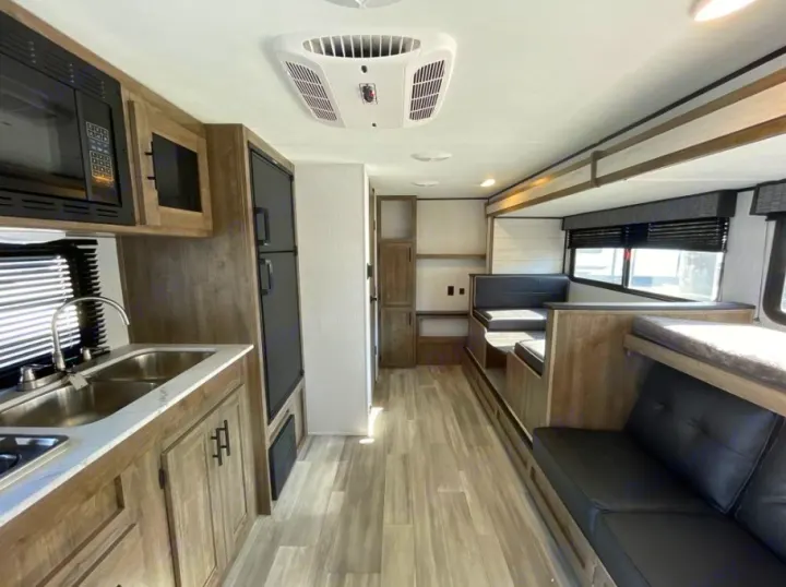 Full interior view of a clean RV rental, showcasing the kitchen, dinette, and comfortable seating areas.. Heartland RVs Pioneer Trail Blazer 2022