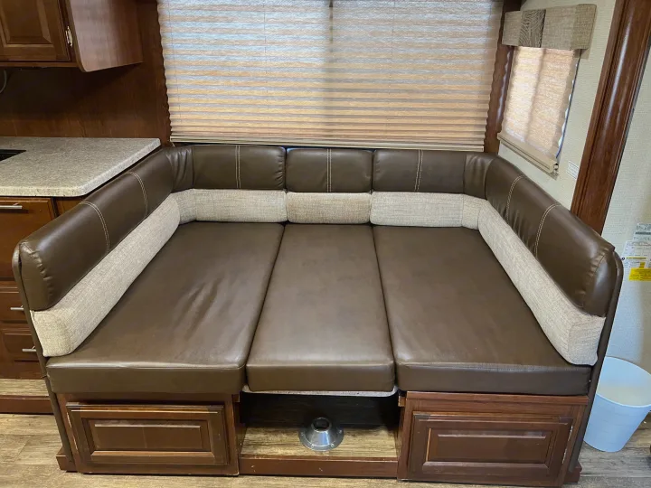 RV rental interior: A brown leatherette and fabric dinette converts into a bed, offering practical, comfortable seating/sleeping space.. Other Other 2018