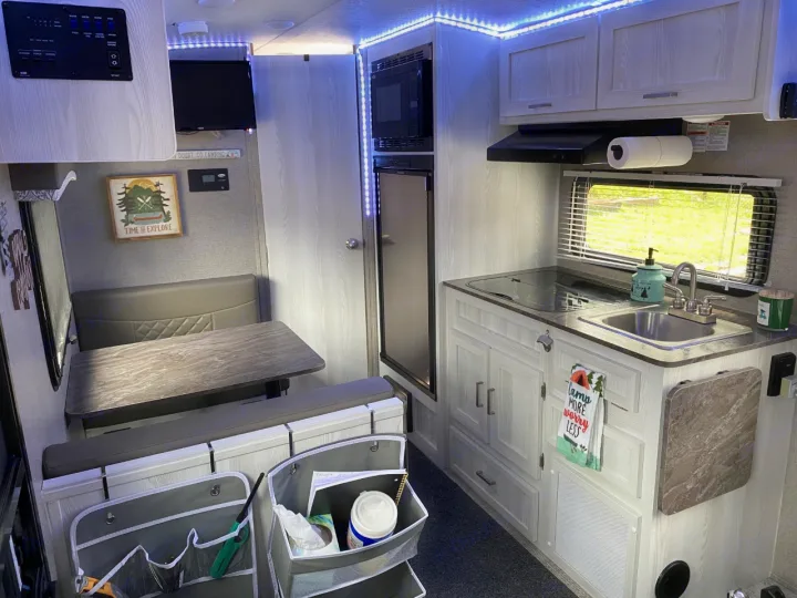 Spacious RV rental interior featuring a bright kitchen and comfortable dining area, ideal for your next camping adventure.. Forest River Rockwood 2020