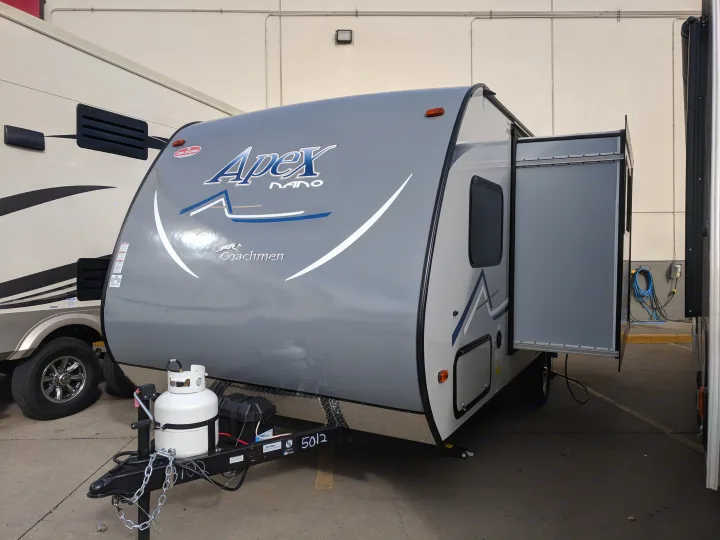 Gray Apex Nano Coachmen travel trailer, perfect for your next rv rental adventure, shown with extended slide-out.. Coachmen Apex 2018