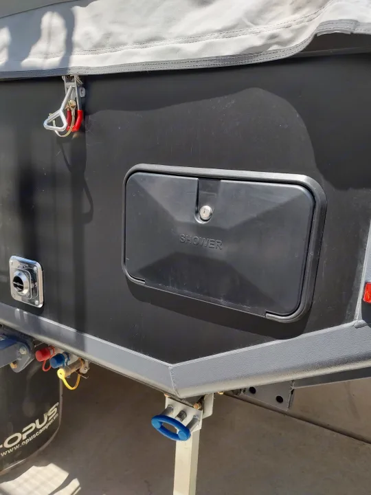 Integrated shower with compartment closed.. Opus Camper Opus Camper Popup Trailer 2021