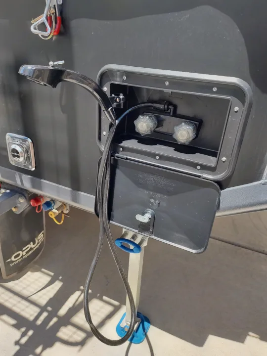 Integrated shower with compartment open.. Opus Camper Opus Camper Popup Trailer 2021