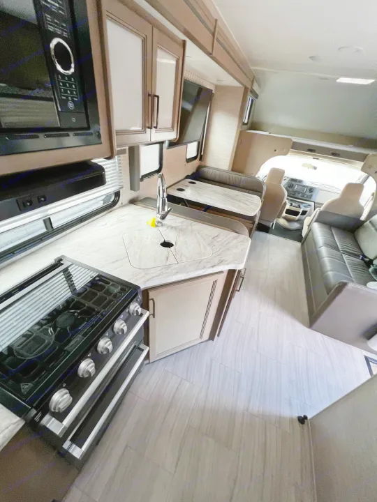 Spacious RV rental interior featuring a modern kitchen, dinette, and driver's cockpit. Perfect for travel.. Coleman Other 2022