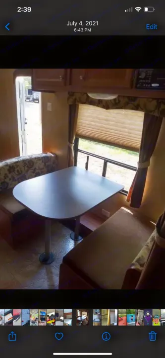 RV rental dinette interior: a table with bench seating, window, and open door. Cozy camper living space.. Jayco Jay Flight Swift 2012