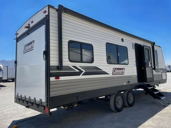This Coleman travel trailer, an ideal RV rental for camping, features a rear ramp door for outdoor adventures.. Coleman 270TQ 2022
