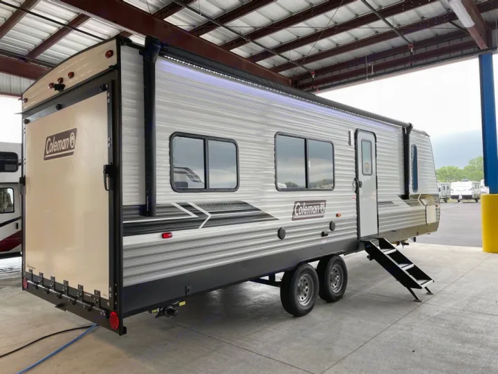 This grey Coleman travel trailer RV rental, with an awning, LED lights, & rear ramp, is perfect for outdoor adventures.. Coleman 270TQ 2022