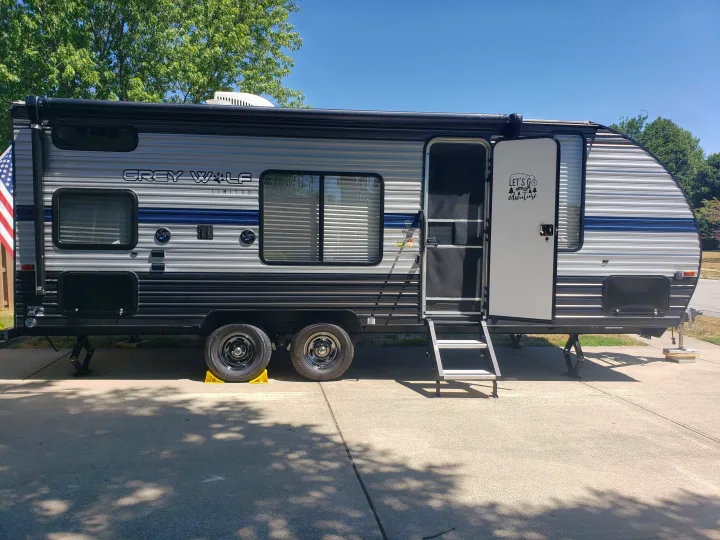 Grey Wolf travel trailer, parked with door open & steps down. This RV rental is ready for your adventure!. Forest River Cherokee Grey Wolf Special Edition 2020