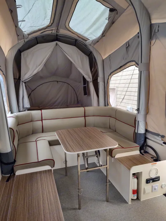 Adjustable camp table height allows personalized leg room.. Opus Camper Opus Camper Popup Trailer 2021