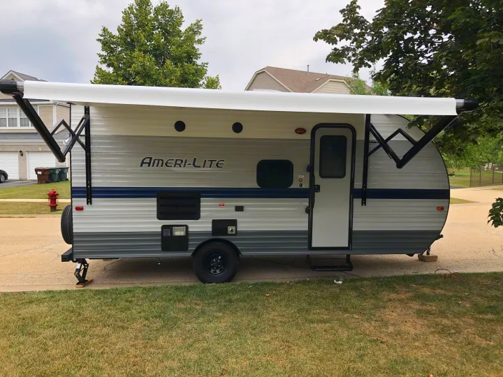 Side view of an Ameri-Lite travel trailer with its awning extended, excellent for an rv rental.. Gulf Stream Ameri-Lite Super Lite 2021