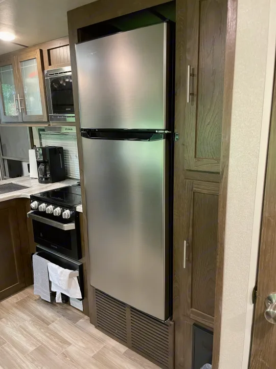 Well-equipped RV rental galley with a large stainless steel refrigerator, microwave, and range. Ready for travel!. Forest River Salem Hemisphere 2020