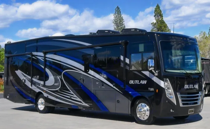 Sleek black RV rental motorhome with blue & gray graphics, perfect for adventurous travel.. Thor Motor Coach Outlaw 2023