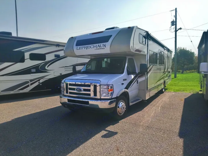 White Ford Coachmen Leprechaun Class C motorhome, ideal for RV rental. Parked outside with other RVs.. Forest River Coachmen Leprechaun 2019
