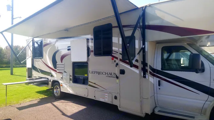 Enjoy the outdoors with this **rv rental** featuring an extended awning, external TV, and handy pull-out table.. Forest River Coachmen Leprechaun 2019