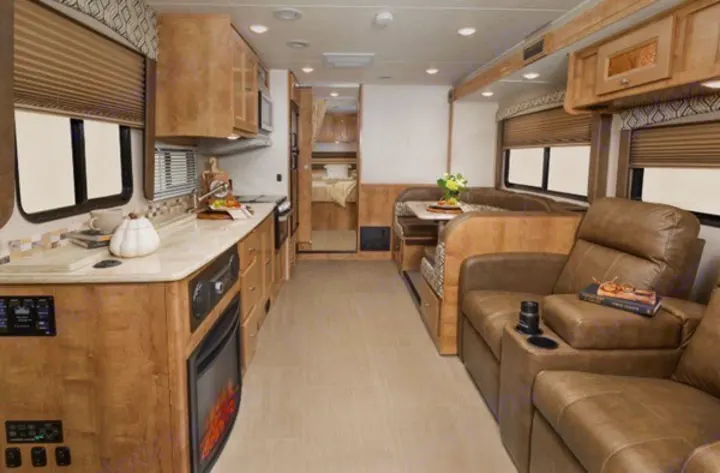 Spacious RV rental interior with full kitchen, dining area, recliners, and bedroom. Perfect for your next adventure!. Forest River Coachmen Leprechaun 2019