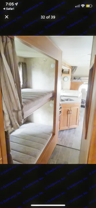 RV rental interior featuring comfy bunk beds on the left and a kitchen with sink and cabinets on the right, for family adventures.. Winnebago Minnie Winnie 2019