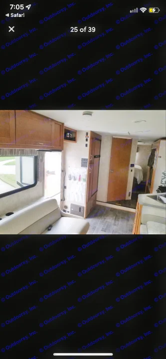 Bright RV rental interior showing a living area with light seating, wood cabinets, and a glimpse into the bedroom beyond. Modern and practical.. Winnebago Minnie Winnie 2019