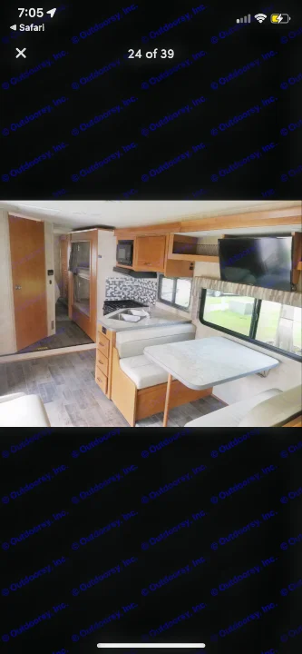 Bright rv rental interior: kitchen with sink & stove, dinette, wall-mounted TV, and bunk beds. Perfect for travel!. Winnebago Minnie Winnie 2019
