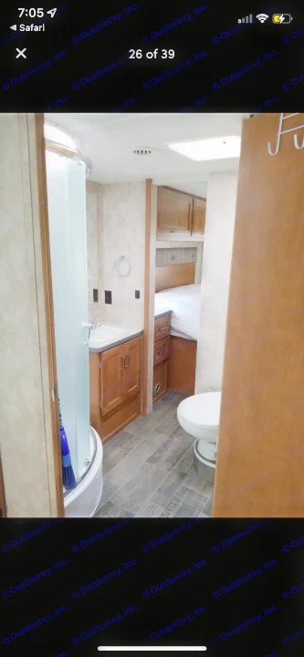 RV rental: well-equipped bathroom with shower, sink vanity, toilet, and a comfortable bedroom visible in the background.. Winnebago Minnie Winnie 2019