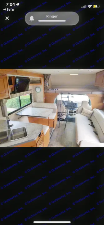 Inside this rv rental: kitchen sink and dinette on left, sofa on right, overhead bunk and driver's cab in front.. Winnebago Minnie Winnie 2019