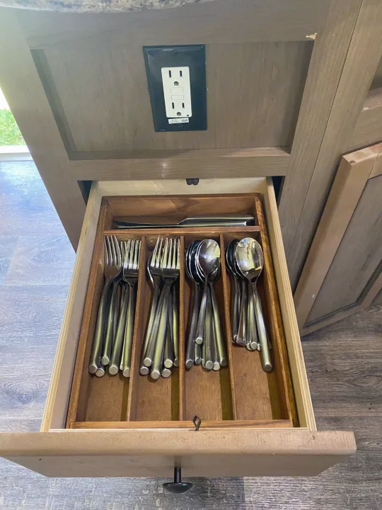 Inside an RV rental: a kitchen drawer organized with silverware, featuring an under-cabinet GFCI outlet.. Cruiser Rv Corp 280Bunkhouse Cruiser 2015