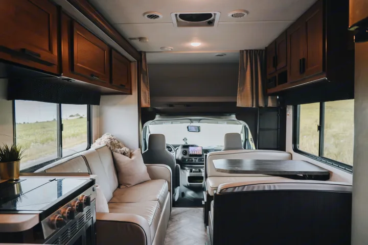 Inside a modern rv rental, this spacious motorhome interior features a functional kitchen, cozy dinette, and inviting lounge area.. Forester LE 2021