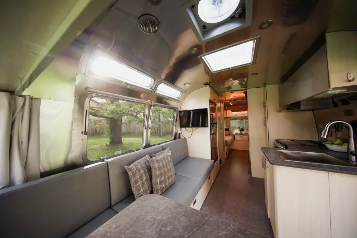 Step inside this modern Airstream RV rental. Features a bright, spacious living area, full kitchen, and rear bedroom.. Airstream Flying Cloud 2021