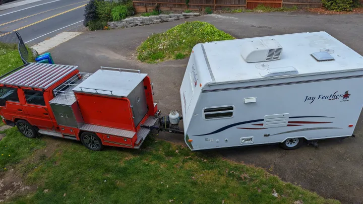 Overhead view: a custom red truck towing a white Jayco travel trailer, perfect for your next RV rental adventure.. Jayco Jay Feather Sport 2007