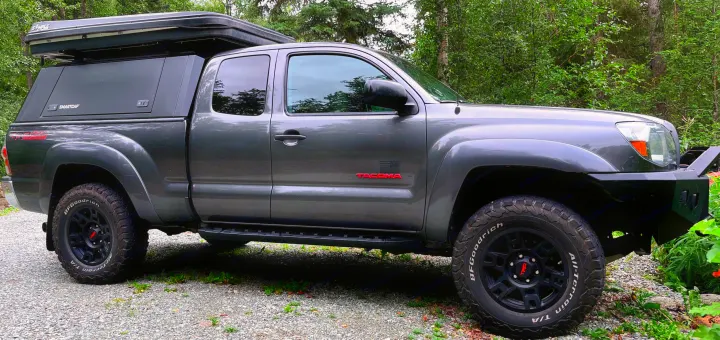 Modified grey Toyota Tacoma truck with SmartCap & rooftop tent, ready for overland camping trips, like an RV rental alternative.. Toyota Other 2010