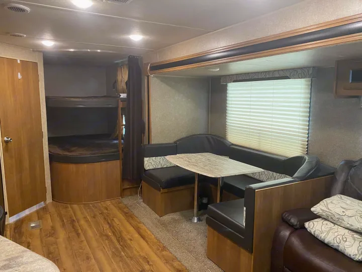 Spacious RV rental interior featuring bunk beds, a dinette, and a cozy living area.. Forest River Coachmen Catalina SBX 2017