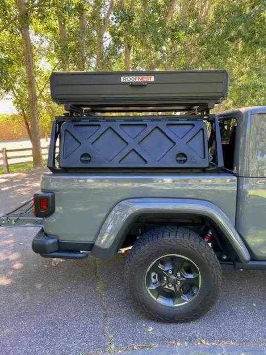Gray Jeep Gladiator with Roofnest rooftop tent and bed rack, ready for adventure. Explore this RV rental option!. Other Other 2021