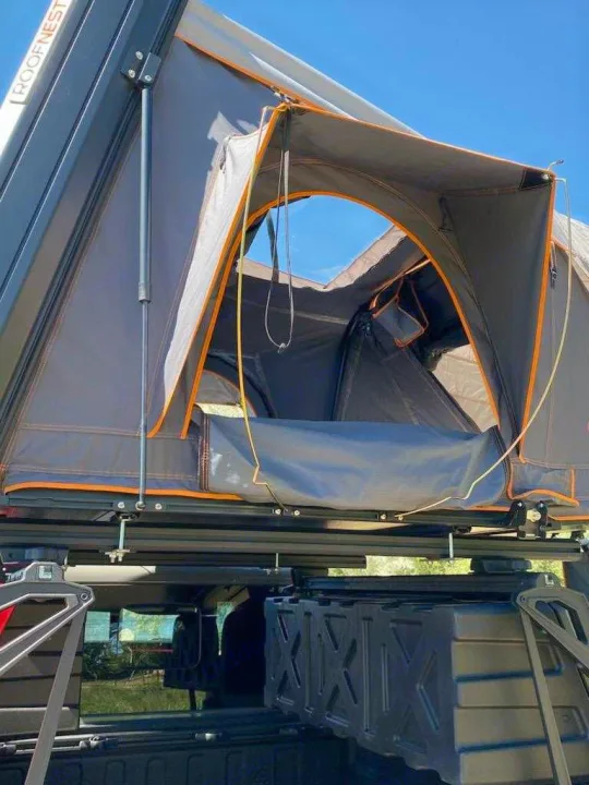 ROOFNEST rooftop tent on a vehicle. Ideal for RV rental camping, showing its open entrance.. Other Other 2021