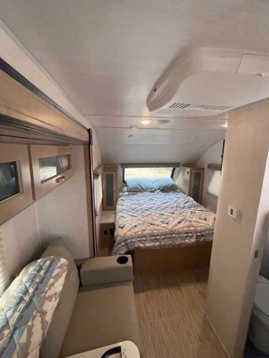Inside a cozy RV rental: a compact bedroom with bed and an inviting living area with sofa seating.. R-Pod Hood River Edition 2020