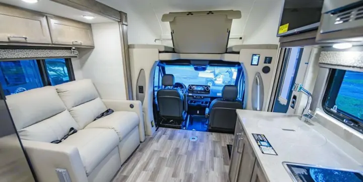 Experience comfortable travel in this modern RV rental. Features a cozy living space, compact kitchen, and driver's cockpit.. Tiffin Motorhomes Wayfarer LW 2023