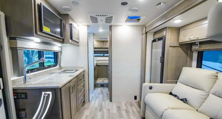 Spacious RV rental interior with kitchen, living area, and sleeping quarters. Modern design for comfortable travel.. Tiffin Motorhomes Wayfarer LW 2023