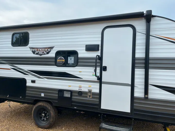 Side view of a modern Wildwood FSX travel trailer, showcasing its features. Perfect for your next RV rental adventure.. Forest River Wildwood FSX 2022