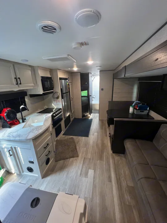 Bright RV rental interior featuring a full kitchen, dinette, and comfortable sofa seating.. Jayco Jay Flight SLX 2022
